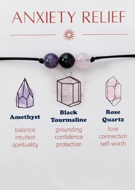Crystal necklace with amethyst, black tourmaline, and rose quartz beads on a white background with text about their properties. Mindfulness and Centering: These pieces often serve as tactile tools—reminders to breathe and refocus during stressful moments, helping you maintain emotional stability and intentionality throughout the day.