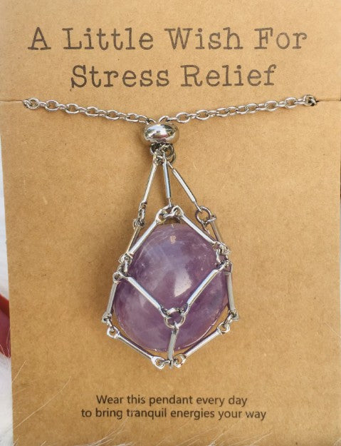 Necklace with a purple pendant on a brown card with text about stress relief. Wearing a quartz stone necklace, particularly clear quartz, offers benefits including amplified energy, enhanced mental clarity, and emotional balance. Often called the "master healer," it is believed to harmonize your aura, aid in manifestation, and improve focus.