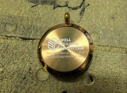 Well Building Connection Logo on Tree of Life Pendant. Portable Wellness: A Tree of Life aromatherapy necklace offers portable, discreet wellness benefits by diffusing essential oils throughout the day, helping to manage stress, boost energy, or improve focus. The locket, often made of hypoallergenic stainless steel, acts as a personal, stylish diffuser, while the Tree of Life symbol represents growth, strength, and harmony.