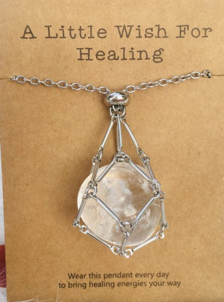 Necklace with a clear stone pendant on a brown card with text. Wearing a quartz stone necklace, particularly clear quartz, offers benefits including amplified energy, enhanced mental clarity, and emotional balance. Often called the "master healer," it is believed to harmonize your aura, aid in manifestation, and improve focus.