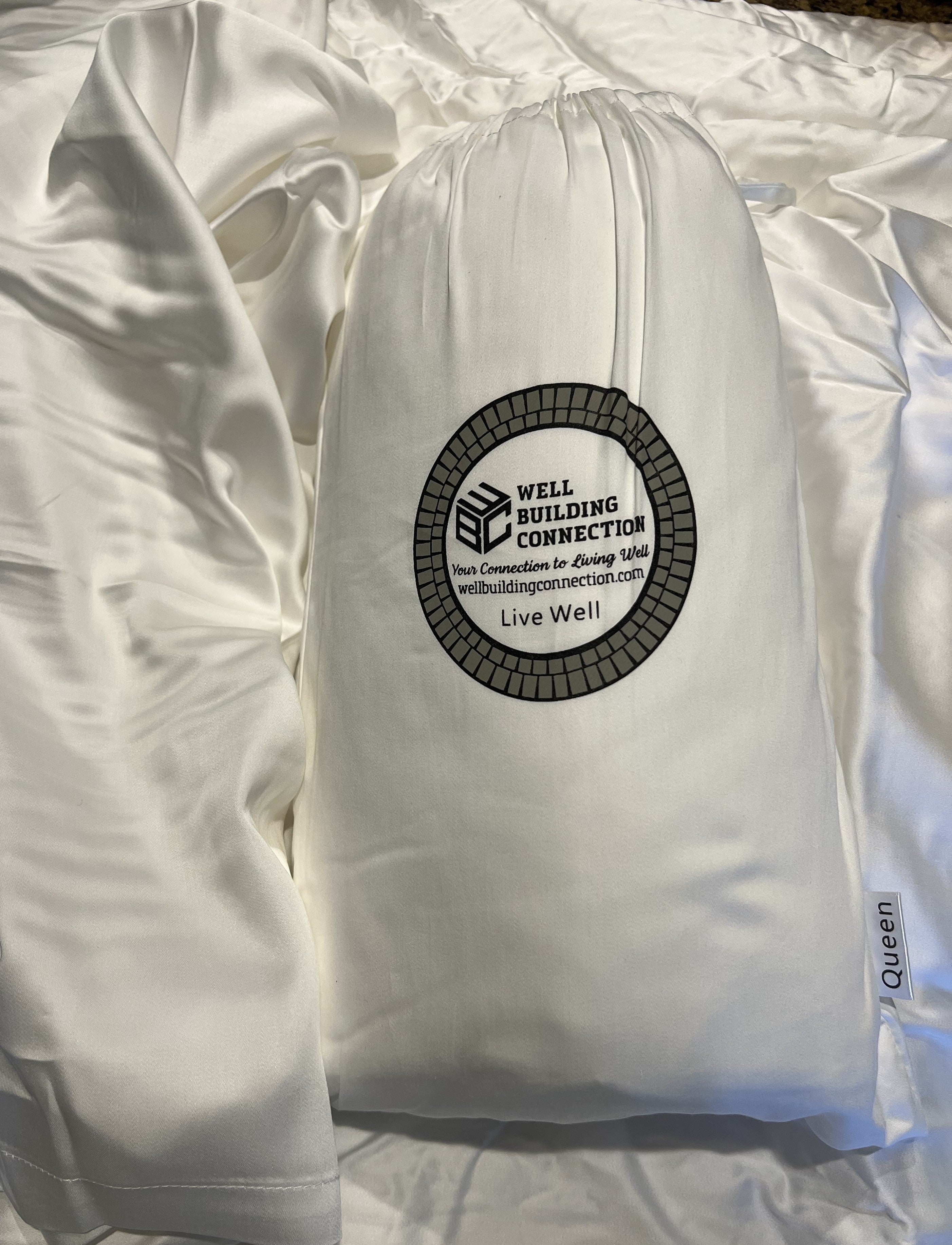 White comforter with a visible brand logo on a white background. Bamboo-Cotton Blend Luxury Sheet Set – Ultimate Comfort &amp; Elegance

Upgrade your sleeping experience with our Bamboo-Cotton Blend Luxury Sheet Set, designed to provide unmatched comfort, durability, and breathability. Crafted from a premium blend of bamboo viscose and high-quality cotton, these sheets offer the perfect balance of softness, strength, and sustainability, ensuring you get the best rest possible. 
Well Building Connection